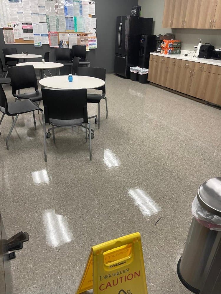 Office lunchroom with round tables and freshly refinished tile floor